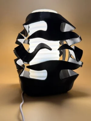 3D Printed Sculptural Ambient Lamp with black flowing exterior and illuminated white centre